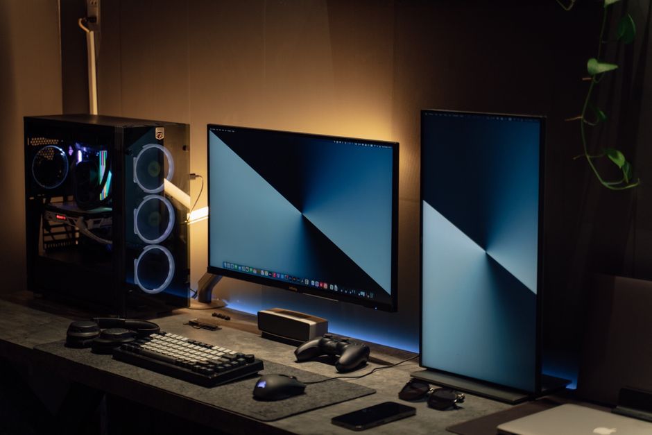 Modern dual monitor PC setup with tech gadgets