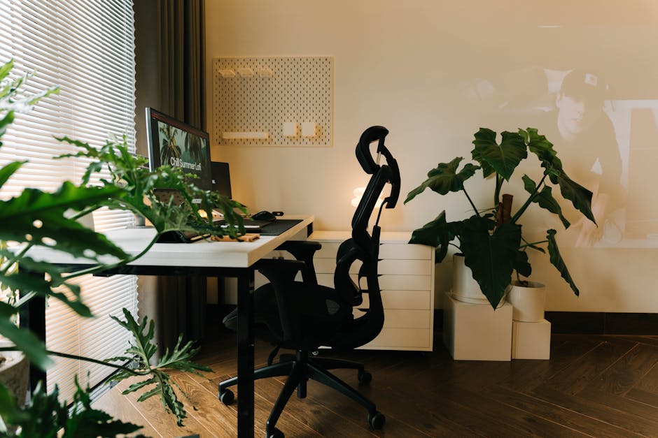 A stylish home office setup with plants and ergonomic chair, perfect for a productive work environment.