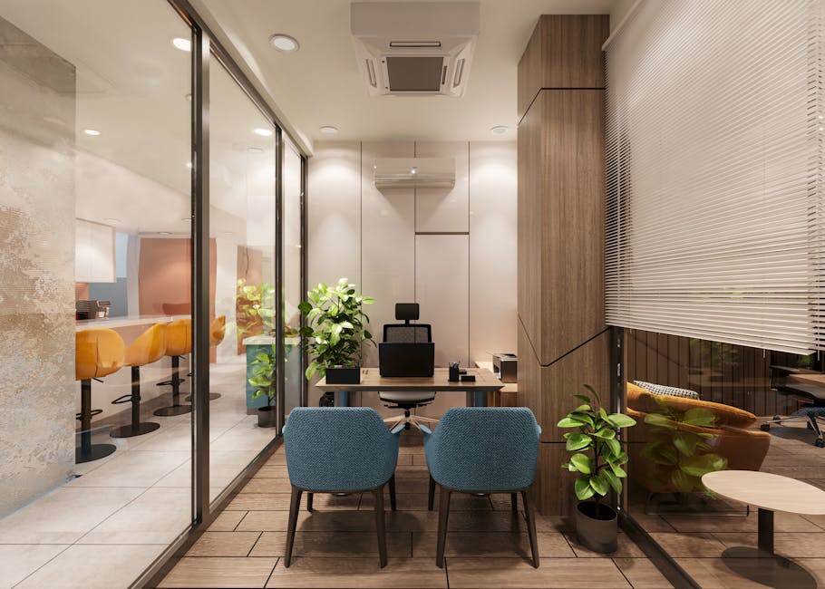 A stylish, modern office interior featuring a meeting area with blue chairs and wooden accents.